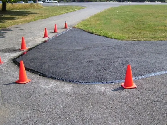 A road with orange cones and cones on it.