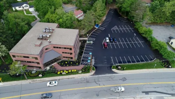 An aerial view of an office building and parking lot.