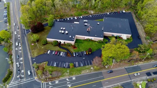 An aerial view of a parking lot and a building.
