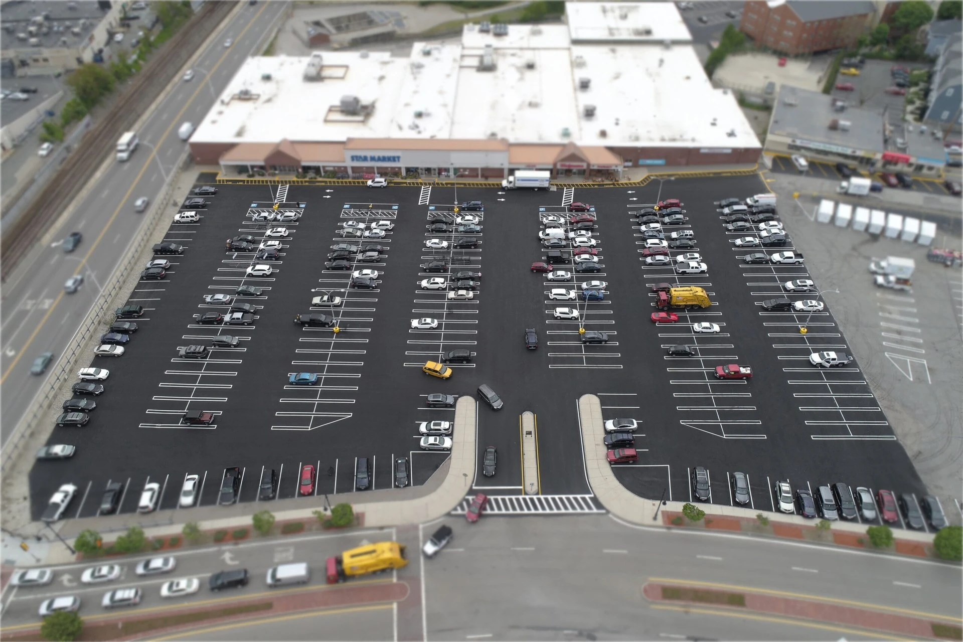 An aerial view of a parking lot with cars parked in it.