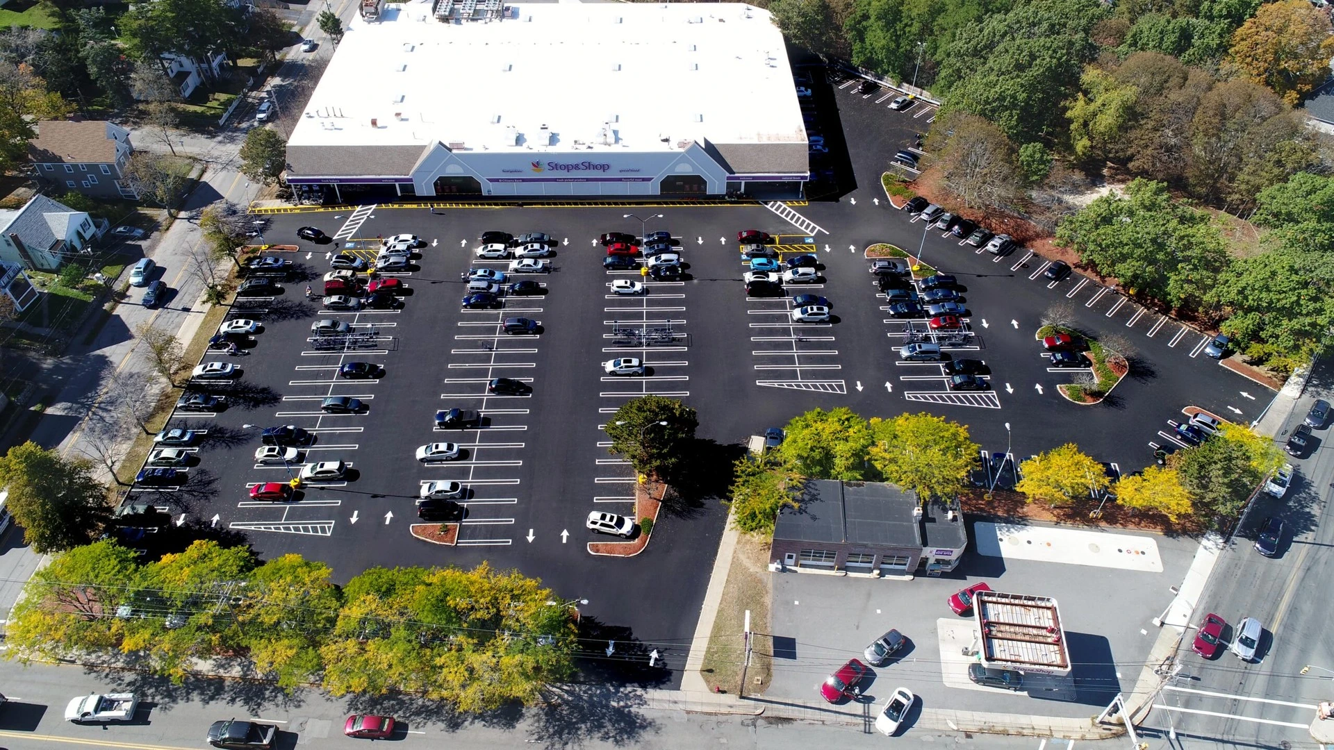 An aerial view of a parking lot with cars parked in it.