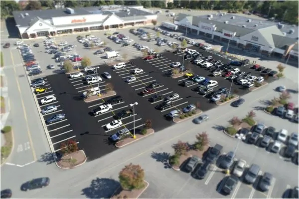 An aerial view of a parking lot with cars parked in it.