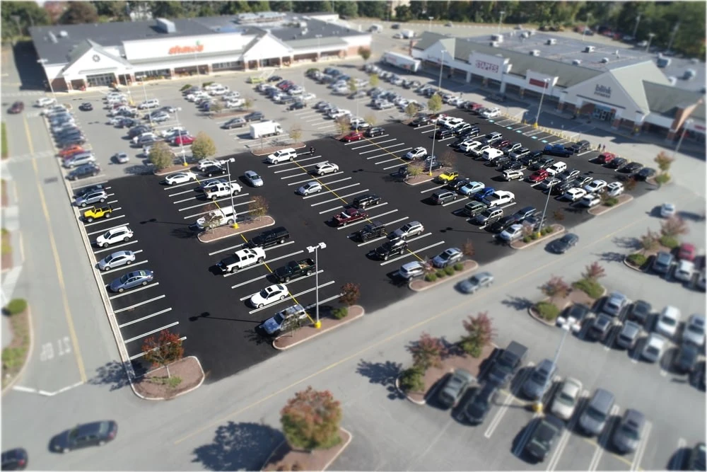 An aerial view of a parking lot with cars parked in it.